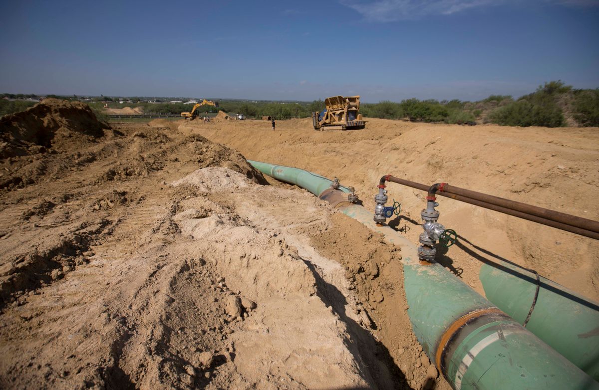 In this Sept. 7, 2014 photo, new pipelines that will carry gas from Texas to Mexico, eventually reaching the city of Guanajuato, are laid underground near General Bravo, in Nuevo Leon state, Mexico. So far this year, thieves across Mexico have drilled so many illegal taps into state-owned pipelines, siphoning off  gas and oil, that they're on pace to set a new annual record. (AP Photo/Eduardo Verdugo) (AP)