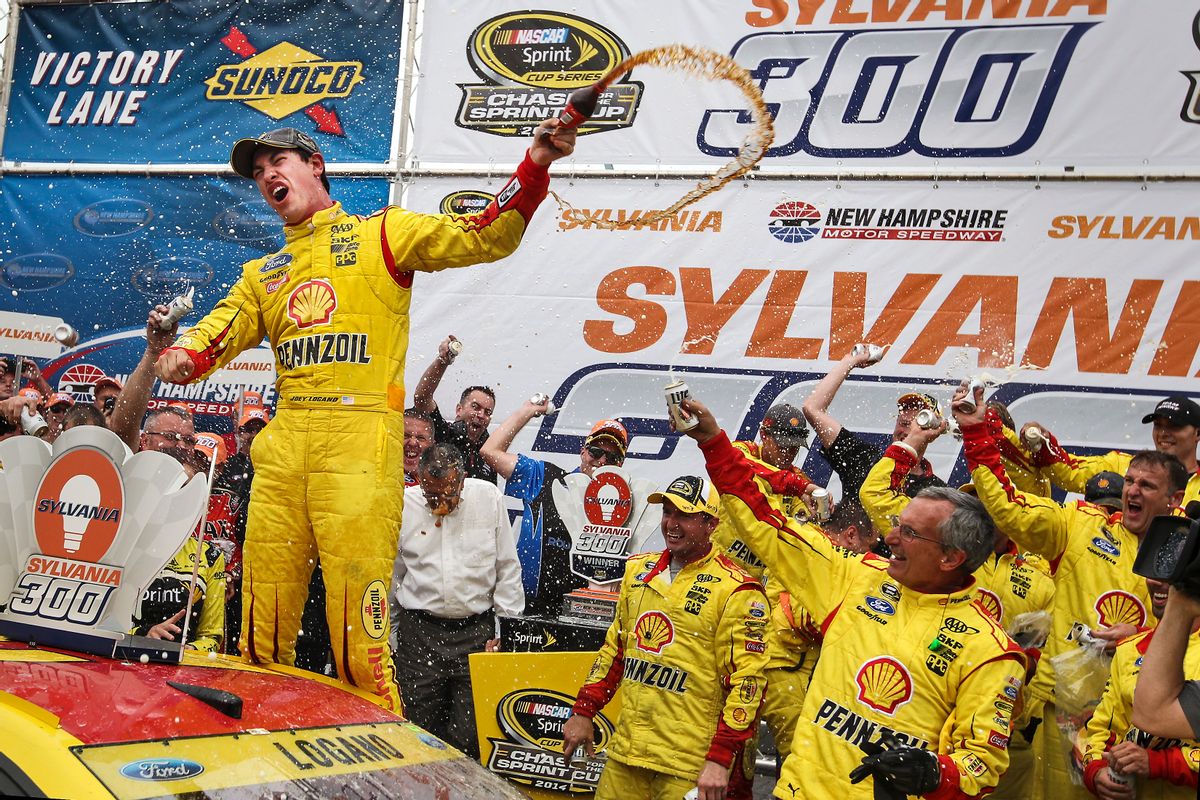 Joey Logano celebrates in Victory Lane after winning the NASCAR Sprint Cup series auto race at New Hampshire Motor Speedway, in Loudon, N.H., Sunday, Sept. 21, 2014. (AP Photo/Cheryl Senter) (AP)