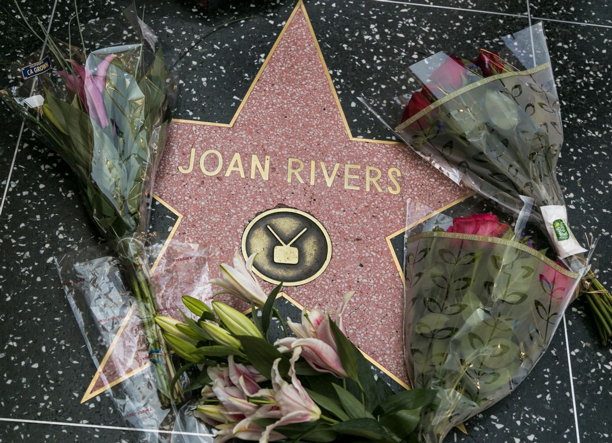 Flowers surround Joan Rivers' star on the Hollywood Walk of Fame in Los Angeles Thursday, Sept. 4, 2014. Rivers, the raucous, acid-tongued comedian who crashed the male-dominated realm of late-night talk shows and turned Hollywood red carpets into danger zones for badly dressed celebrities, died Thursday. She was 81.  (AP Photo/Damian Dovarganes)  (AP)