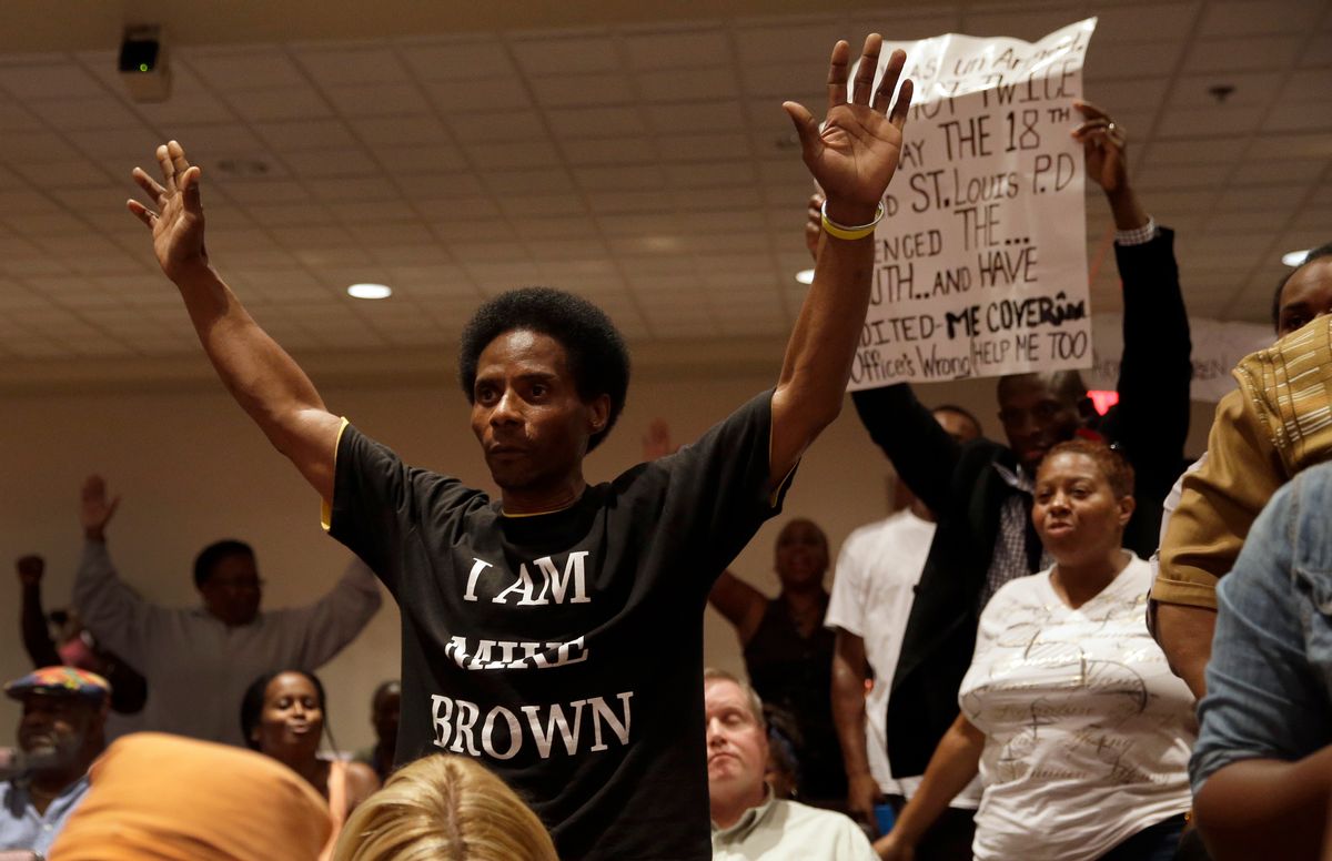 Larry Miller holds up his hands after speaking during a public comments portion of a meeting of the Ferguson City Council Tuesday, Sept. 9, 2014, in Ferguson, Mo. The meeting is the first for the city council since the fatal shooting of Michael Brown by a city police officer.    (AP/Jeff Roberson)