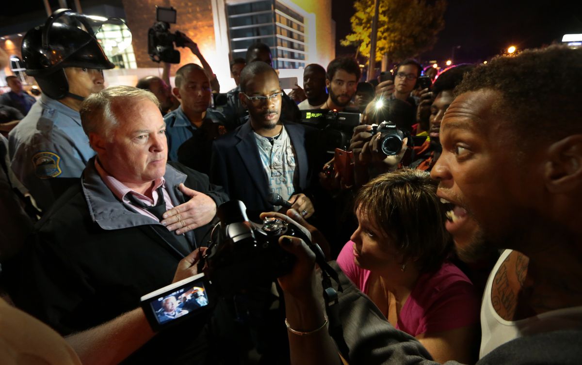 Ferguson Police Chief Tom Jackson, left, speaks before protesters in front of the Ferguson Police Department, on Thursday, Sept. 25, 2014. (AP Photo/St. Louis Post-Dispatch, Robert Cohen)      (AP/St. Louis Post-Dispatch, Robert Cohen)