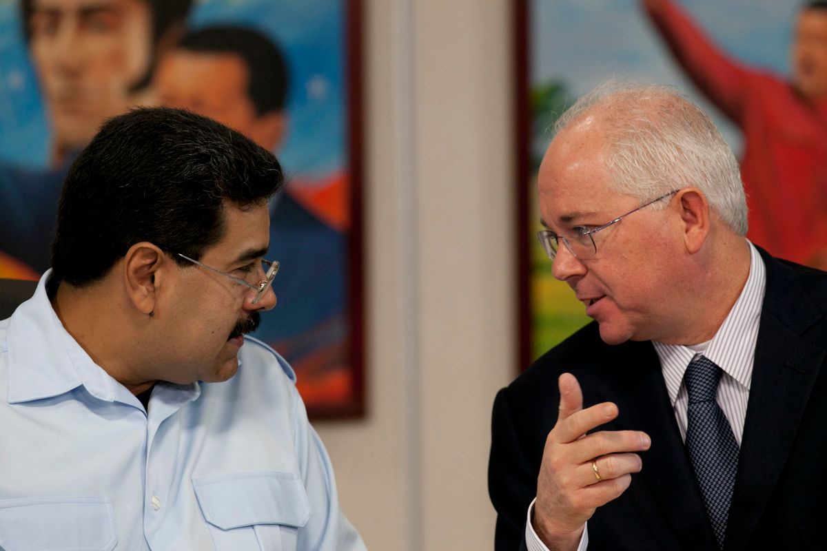 FILE - In this Nov. 15, 2013, file photo, Venezuela's President Nicolas Maduro, left, speaks with his Oil Minister Rafael Ramirez before the start of a press conference at Miraflores presidential palace in Caracas, Venezuela. President Maduro has replaced on Tuesday Sept. 2, 2014, Venezuela's longtime oil minister and economic czar as part of a cabinet shakeup sidelining the most-prominent voice within his administration for much-needed reforms to address the country's economic crisis.  (AP Photo/Ariana Cubillos, File) (AP)