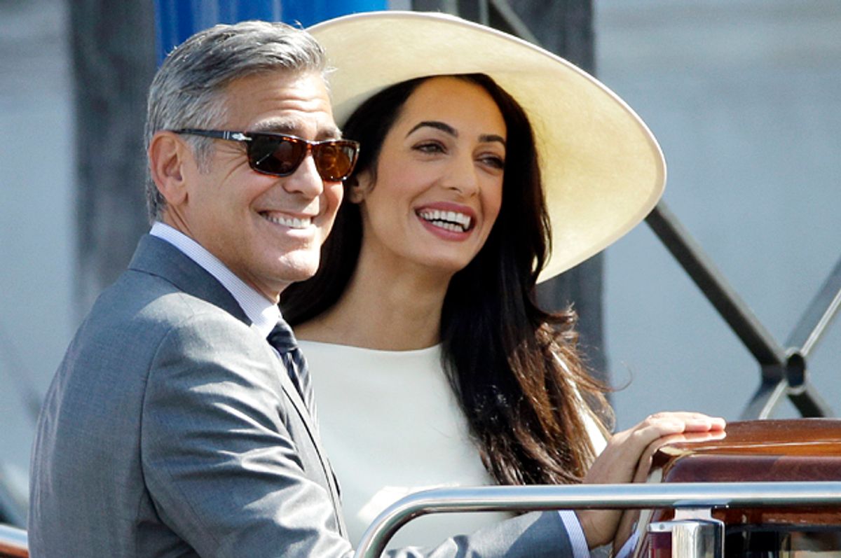 George Clooney and Amal Alamuddin leave Venice's city hall, Italy, Monday, Sept. 29, 2014. Clooney and Amal married Saturday, Sept. 27, the actor's representative said, out of sight of pursuing paparazzi and adoring crowds. (AP Photo/Andrew Medichini)      (Andrew Medichini)