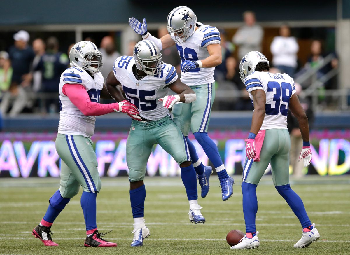 Dallas Cowboys middle linebacker Rolando McClain (55) celebrates with teammates after he intercepted a pass late in the second half of an NFL football game against the Seattle Seahawks, Sunday, Oct. 12, 2014, in Seattle. The Cowboys won 30-23. (AP Photo/Scott Eklund) (AP)