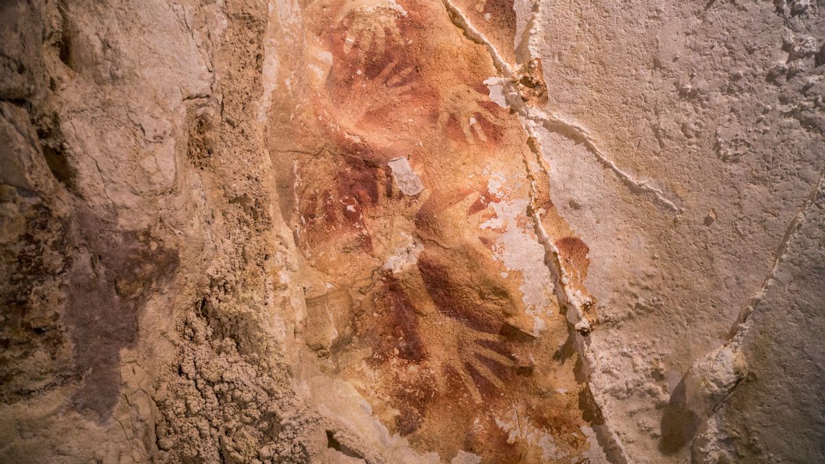This undated handout photo provided by Nature Magazine shows stencils of hands in a cave in Indonesia. Ancient cave drawings in Indonesia are as old as famous prehistoric art in Europe, according to a new study that shows our ancestors were drawing all over the world 40,000 years ago. And it hints at an even earlier dawn of creativity in modern humans, going back to Africa, than scientists had thought. (AP/Kinez Riza, Nature Magazine)
