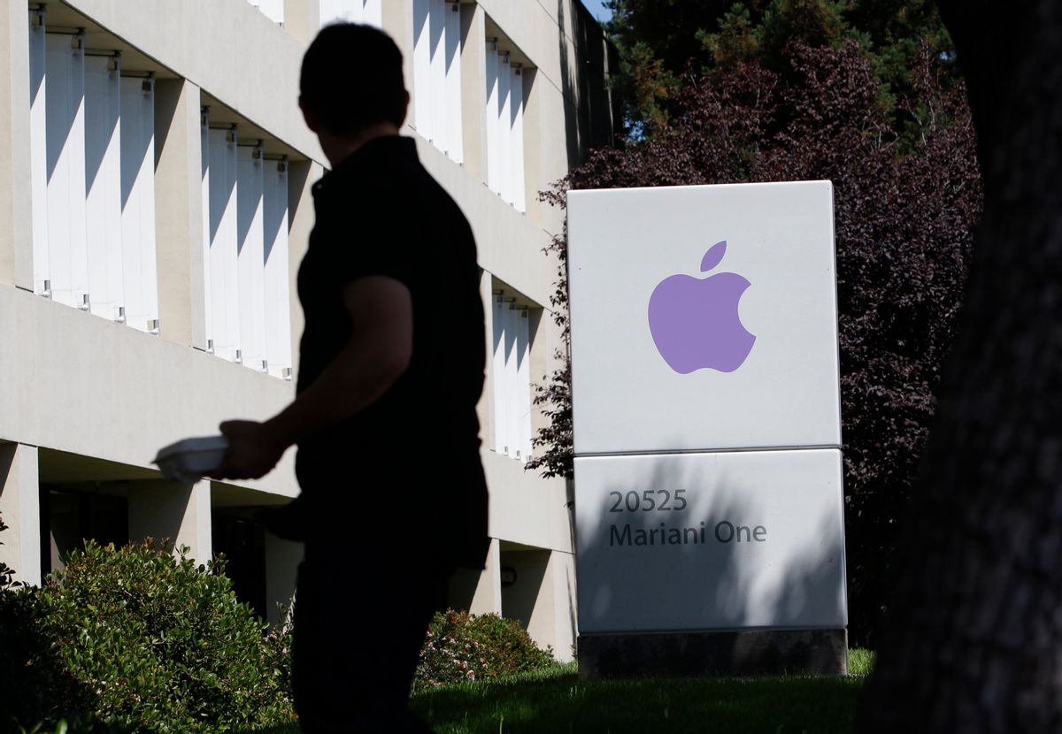 FILE - In this Aug. 25, 2011 file photo, an Apple employee walks between Apple buildings at Apple headquarters in Cupertino, Calif. Facebook and Apple, long known for cushy perks such as free meals, laundry service and massages, are among some of Silicon Valley's biggest companies. (AP Photo/Paul Sakuma, File)  (AP)
