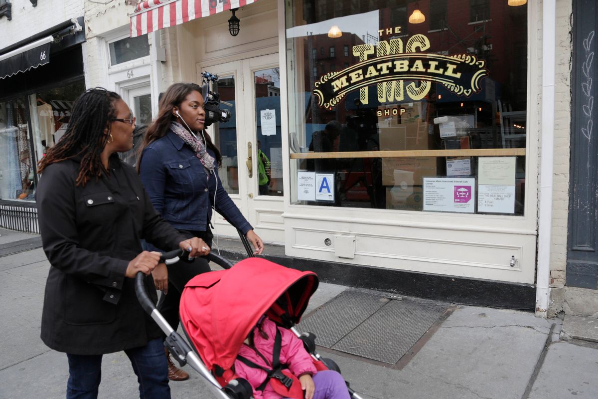 People walk past The Meatball Shop, Friday, Oct. 24, 2014, in the Greenwich Village neighborhood of New York. Dr. Craig Spencer, who has been diagnosed with Ebola, recently ate at the restaurant, which was temporarily closed Friday as a precaution. (AP Photo/Mark Lennihan) (AP)