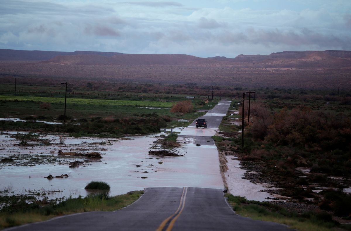 FILE - In this Monday, Sept. 8, 2014 file photo, a truck crosses floodwaters on a road in Moapa, Nev. Monsoon season in the Southwest, which officially ended Sept. 30, will go down as a record-breaker. Meteorologists say some areas in Arizona, Nevada and New Mexico received more rain in one day than in a normal summer. The intense amount of moisture also brought flood damage that is still being felt in homes and roads throughout the region. (AP Photo/John Locher,File) (AP)