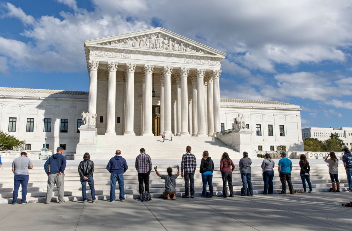 As the Supreme Court begins its new term this week, pro-life advocates hold a prayer vigil on the plaza of the high court in Washington, Saturday, Oct. 4, 2014. The group, Bound 4 Life, has come to the court for ten years to make a silent appeal against abortion.   (AP)