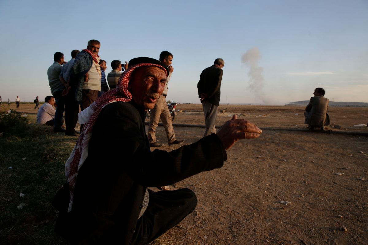 Turkish Kurds watch as airstrikes hit Kobani, inside Syria, as fighting intensifies between Syrian Kurds and the militants of Islamic State group, in Mursitpinar, on the outskirts of Suruc, at the Turkey-Syria border, Wednesday, Oct. 8, 2014. Kobani, also known as Ayn Arab and its surrounding areas have been under attack since mid-September, with militants capturing dozens of nearby Kurdish villages. (AP Photo/Lefteris Pitarakis) (AP)