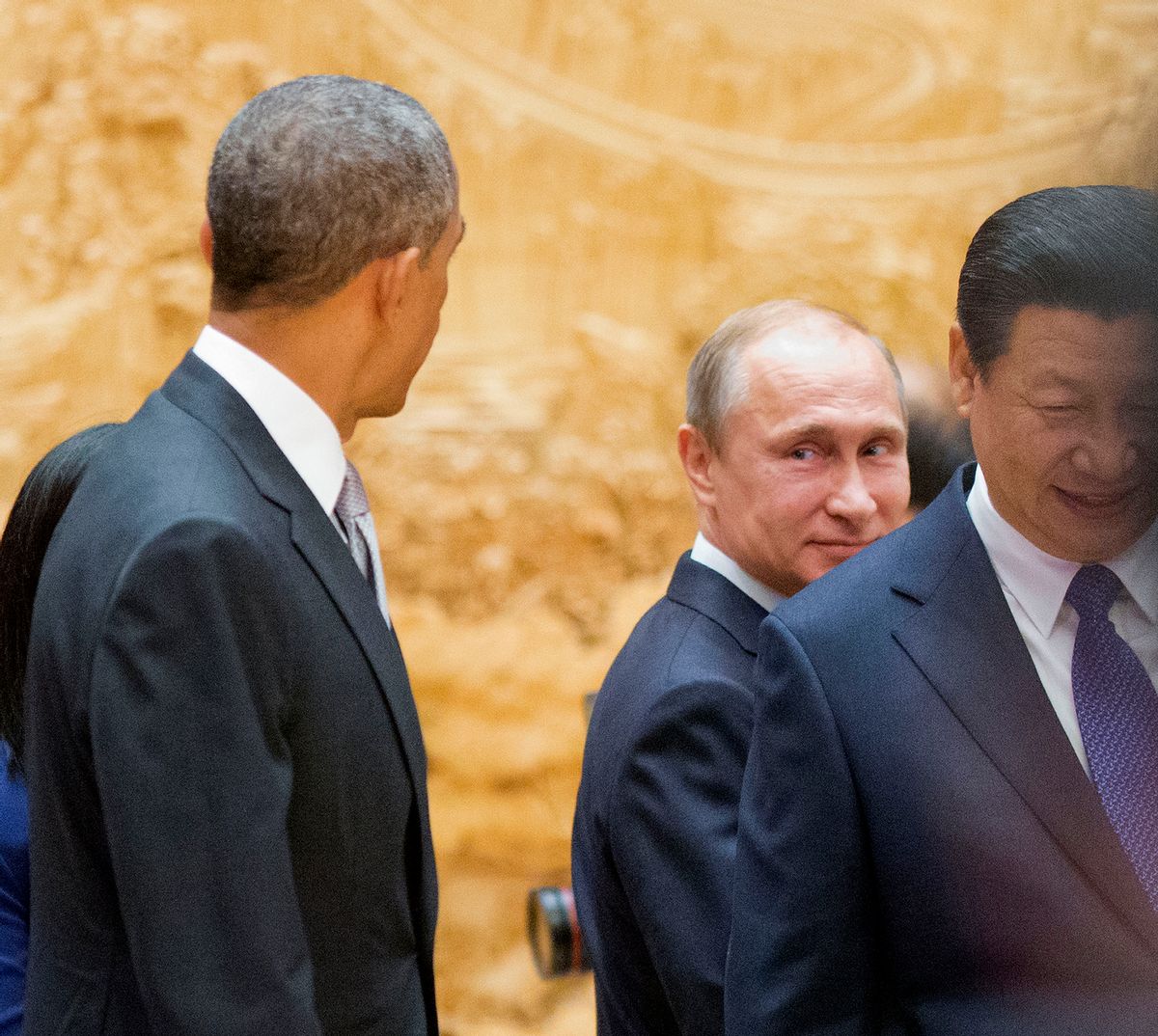 Russian President Vladimir Putin, center, looks back at US President Barack Obama, left, as they arrive with Chinese President Xi Jinping, right, at the the Asia-Pacific Economic Cooperation (APEC) Summit. (AP/Pablo Martinez Monsivais)