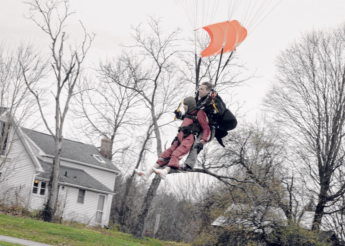 In this Saturday, Nov. 8, 2014 photo, Eleanor "Nanny" Cunningham, left, with tandem master Dean McDonald, come in for a landing after their skydive in Gansevoort, N.Y, a day after her 100th birthday. It was Cunningham's third jump, after taking up the sport at age 90. (AP Photo/The Albany Times Union, Michael P. Farrell)  TROY, SCHENECTADY; SARATOGA SPRINGS; ALBANY OUT (AP)