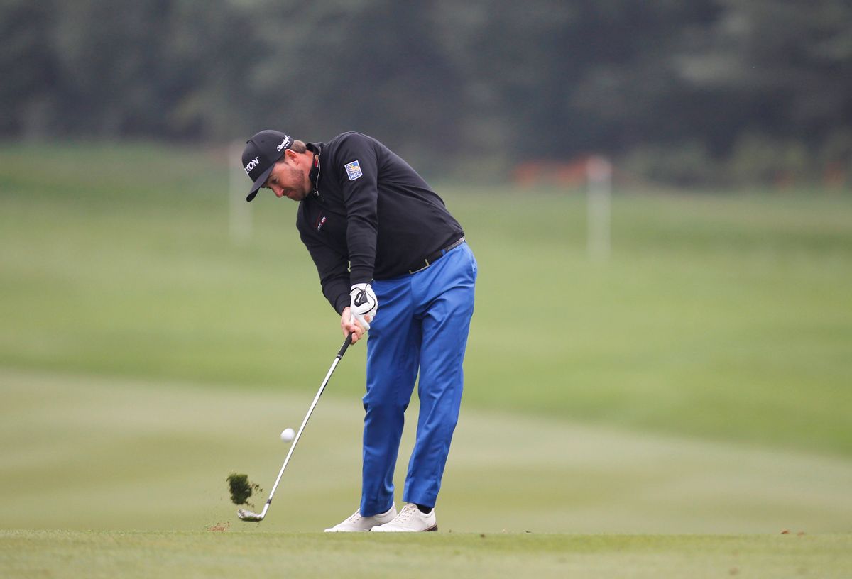 Graeme Mcdowell of Northern Ireland hits a shot at 10th hole during the 3rd round of the HSBC Champions golf tournament at the Sheshan International Golf Club in Shanghai, China Saturday Nov.8, 2014. (AP Photo) (AP)