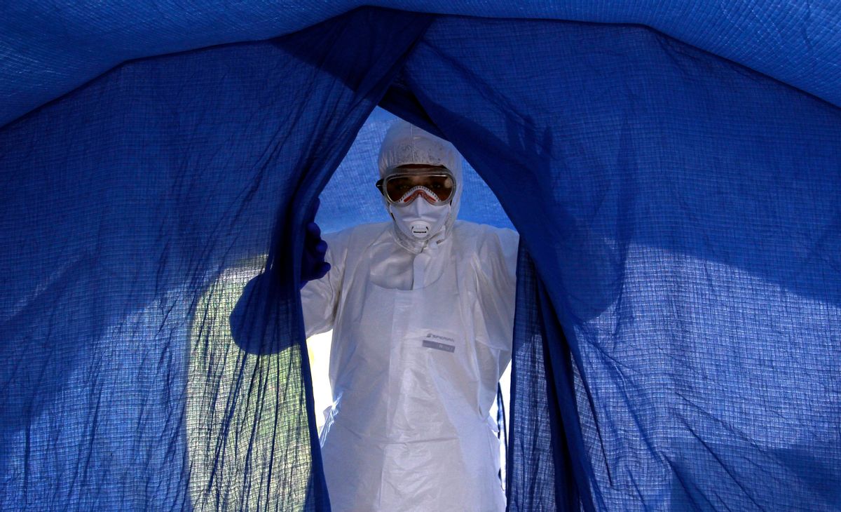 In this file photo taken on Sept. 24, 2014, nurse Dalila Martinez, trainer of the Cuban medical team to travel to Sierra Leone, enters a tent during a practice drill at a training camp, in Havana, Cuba. (AP Photo/Ladyrene Perez, Cubadebate, File)  