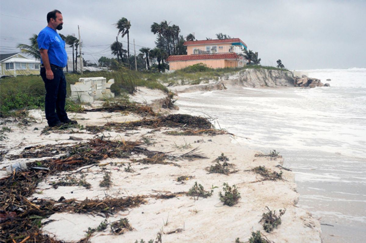 Tim Change, from the Bradenton Beach Public Works Dept., inspects beach erosion as a storm surge and high winds associated with Tropical Storm Debby batter Bradenton Beach, Fla., June 25, 2012.                (Reuters)
