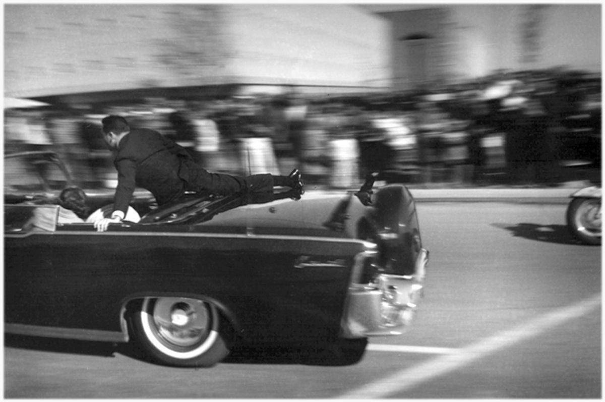 The limousine carrying mortally wounded President John F. Kennedy races toward the hospital seconds after he was shot in Dallas, Nov. 22, 1963.         (AP/Justin Newman)