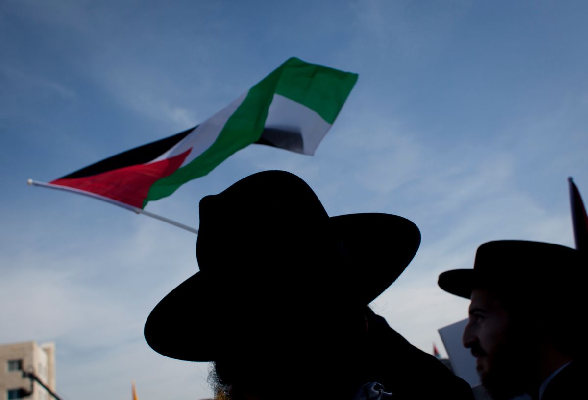 FILE - In this file photo taken Tuesday, Nov. 11, 2014, a member of the international organization of Orthodox Jews, Neturei Karta, waves a Palestinian flag while attending a ceremony marking the 10th anniversary of the late Palestinian leader Yasser Arafat's death, at the Palestinian Authority headquarters, in the West Bank city of Ramallah. Palestinian President Mahmoud Abbas on Tuesday accused Israel of provoking a "religious war" as new violence between the sides broke out in the West Bank, leaving a Palestinian man dead, amid mounting concerns that their long-running conflict is entering a new and dangerous phase. (AP Photo/Nasser Nasser, File) (AP)