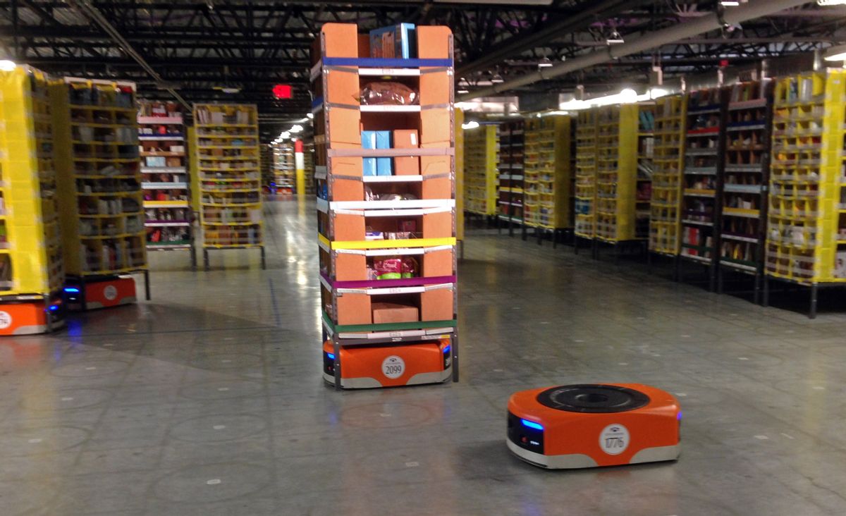 A Kiva robot drive unit is seen, foreground, before it moves under a stack of merchandise pods, seen on a tour of one of Amazon's newest distribution centers in Tracy, Calif., Sunday, Nov. 30, 2014. This Amazon Fulfillment Center opened in 2013 and was refitted to use new robot technology in the summer of 2014. All year Amazon has been investing in ways to make shipping faster and easier to prepare for this holiday season. At this Northern California warehouse the company is employing robotics and other new technology to help workers process the annual onslaught of shopping orders. (AP Photo/Brandon Bailey) (AP)