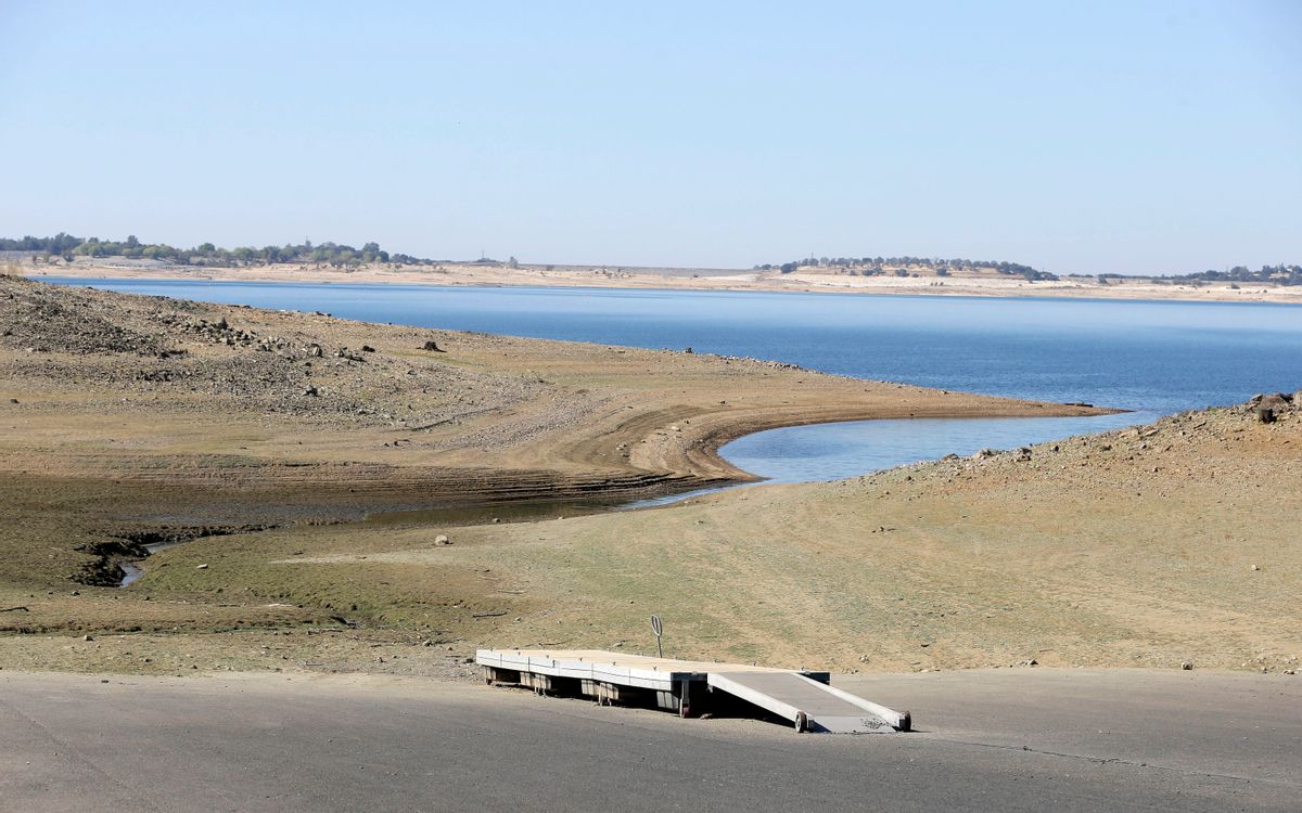 In this Oct. 6, 2014 file photo, a dock sits high and dry at the end of a boat ramp yards away from the edge of Folsom Lake near Folsom, Calif. (AP Photo/Rich Pedroncelli, File)  