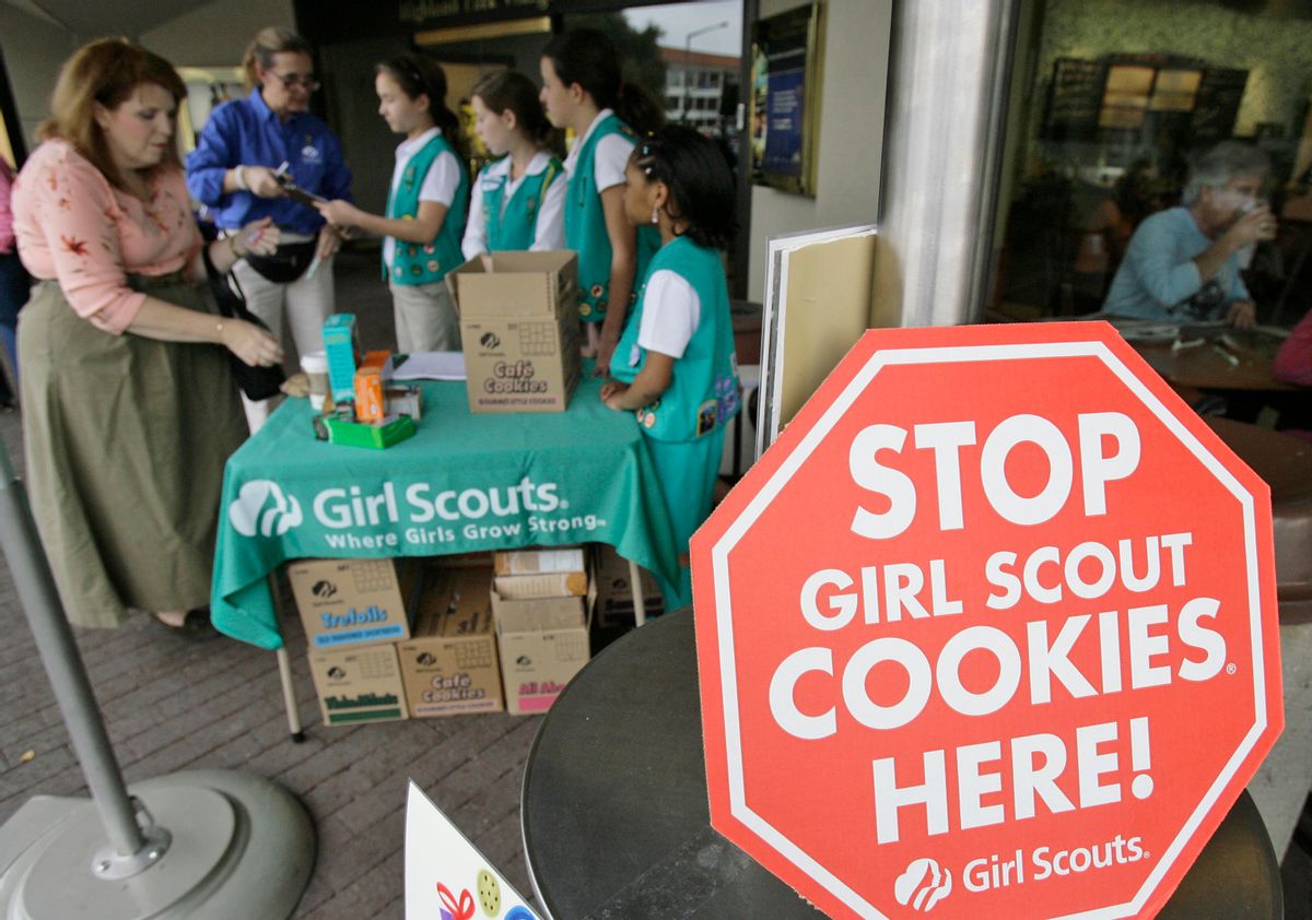 Girl Scouts from the Texas Council sell cookies,  Friday, Feb. 23, 2007, in Dallas. The Girl Scouts have marked their 90th year in the cookie business by getting most of the artificial fat out of all varieties of their iconic treats, which had been under attack by a few health-focused consumer groups. (AP Photo/Matt Slocum) (AP)