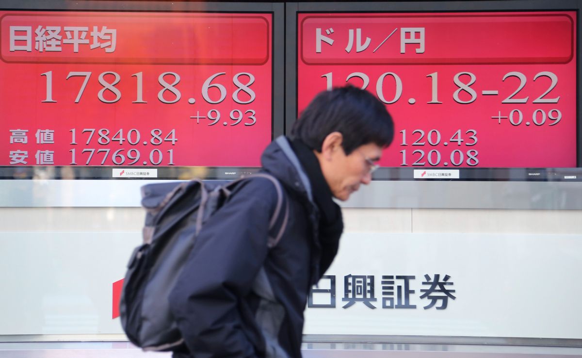 A man walks by an electronic stock board of a securities firm in Tokyo, Friday, Dec. 26, 2014 . (AP Photo/Koji Sasahara) (Koji Sasahara)