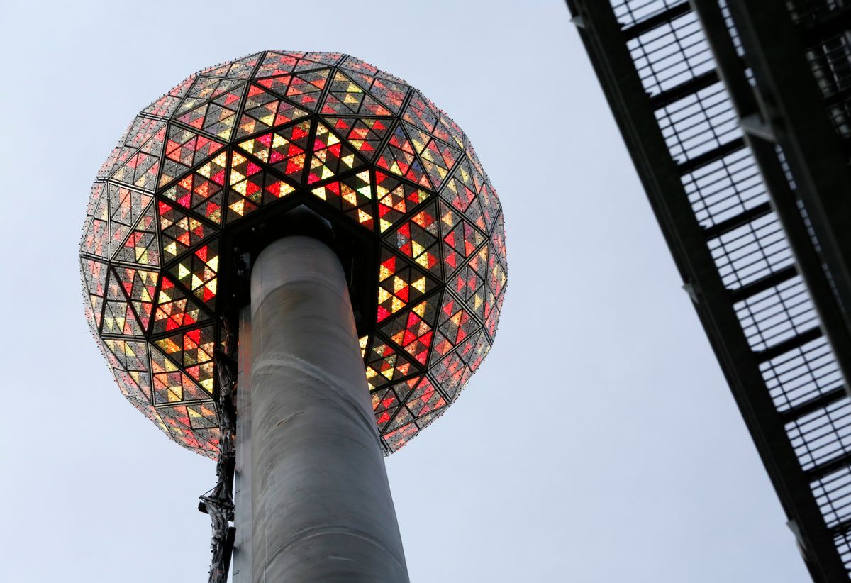 Workers light the Waterford crystal ball during a test for the New Year's Eve celebration atop One Times Square in New York, Tuesday, Dec. 30, 2014. The ball, which is 12 feet in diameter and weighs 11,875 pounds, is decorated with 2,688 Waterford crystals and illuminated by 32,256 LED lights. (AP Photo/Kathy Willens) (AP)
