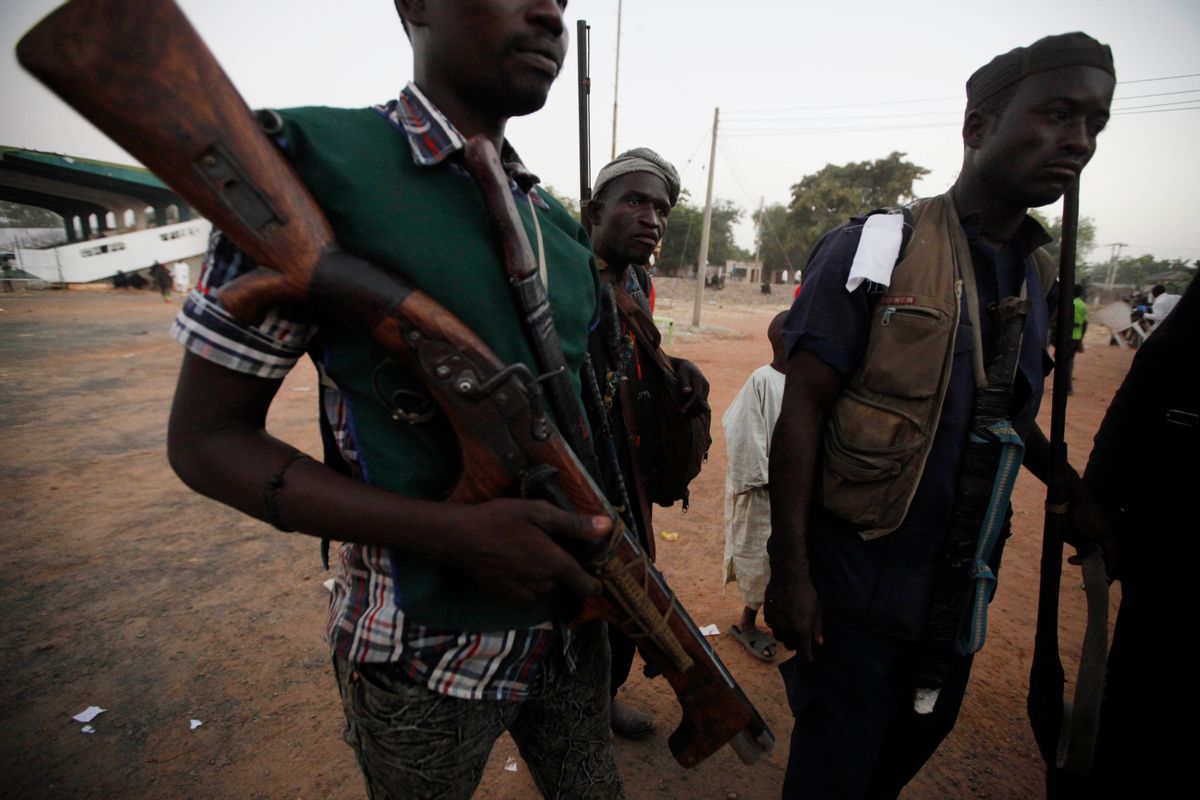 Vigilantes and local hunters armed with locally made guns gathered before they go on patrol in Yola, Nigeria. (AP/Sunday Alamba)