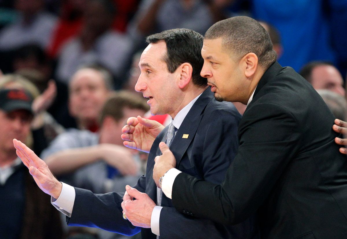 Duke head coach Mike Krzyzewski, left, is hugged by associate head coach Jeff Capel after getting his 1,000th career win in an NCAA college basketball game against St. John's at Madison Square Garden in New York, Sunday, Jan. 25, 2015. Krzyzewski became the first men's coach in Division I history with 1,000 wins. (AP Photo/Kathy Willens) (AP)