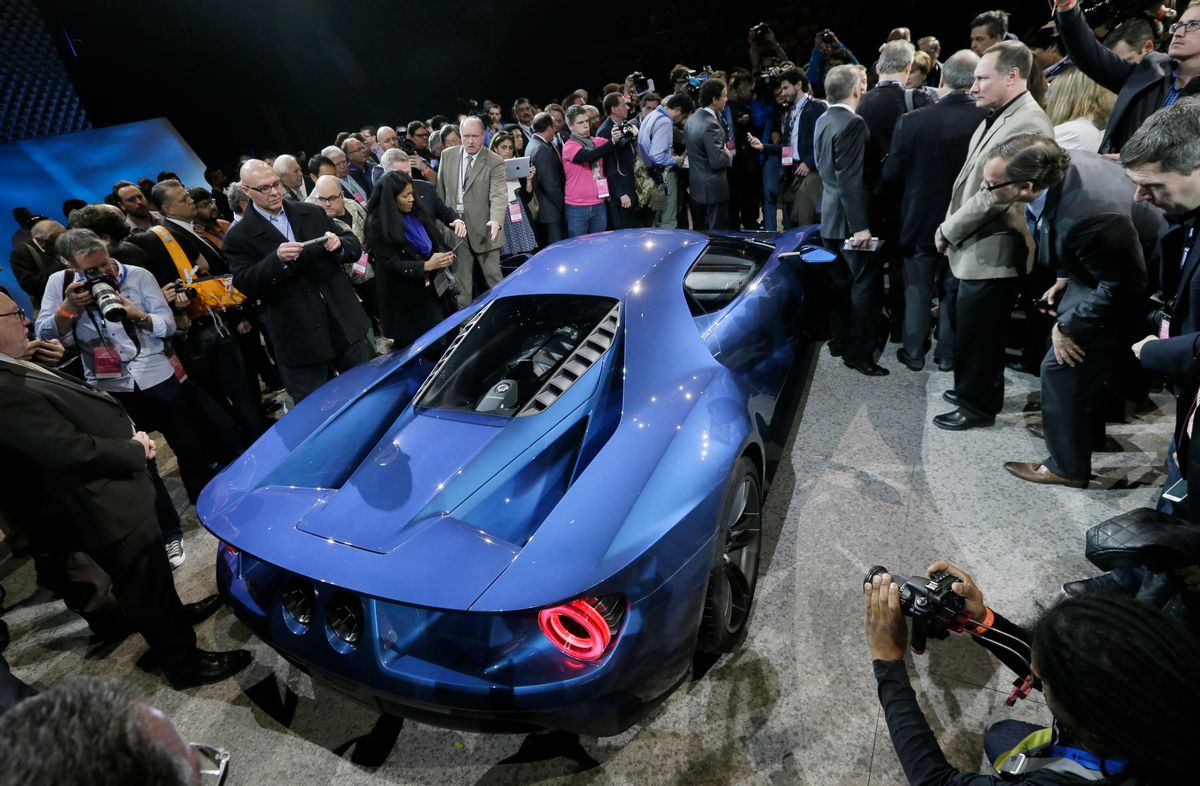 Journalists surround the new Ford GT after it was unveiled at the North American International Auto Show, Monday, Jan. 12, 2015 in Detroit. (AP Photo/Carlos Osorio) (AP)