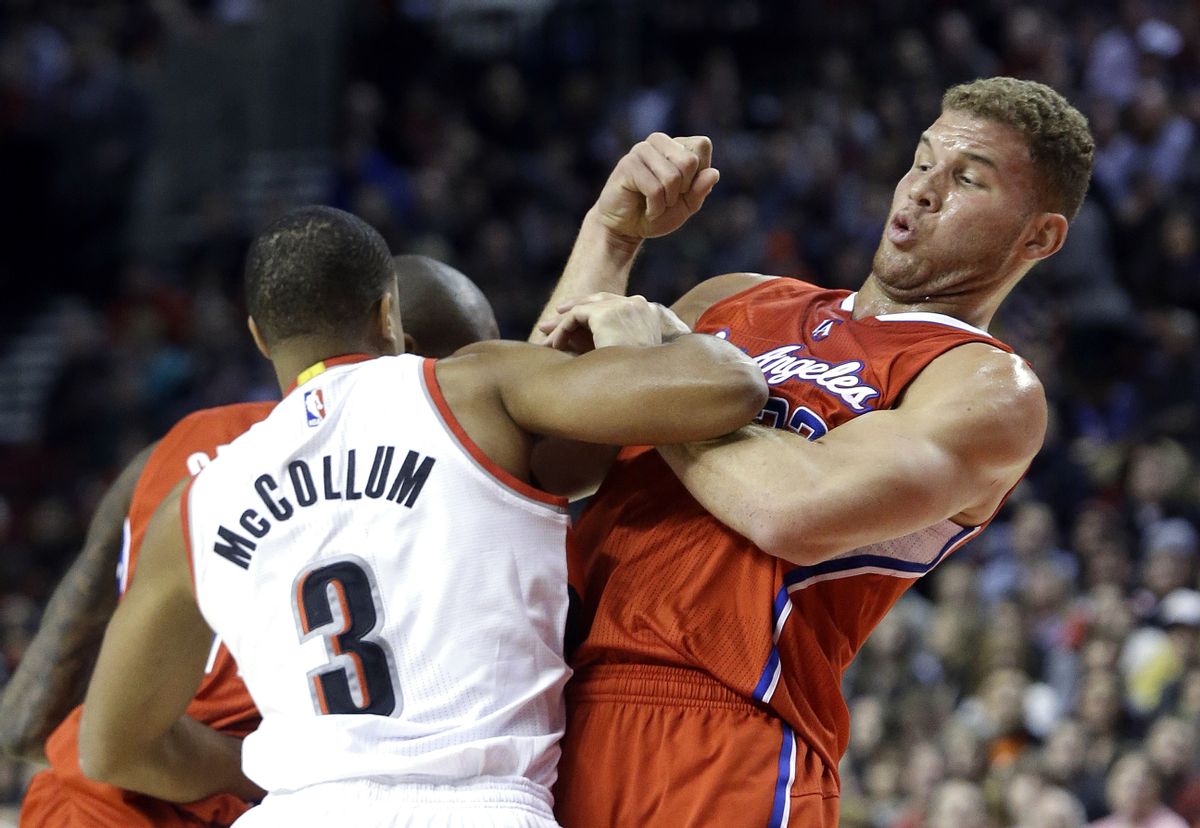 Los Angeles Clippers forward Blake Griffin, right, gets tangled up with Portland Trail Blazers guard CJ McCollum during the first half of an NBA basketball game in Portland, Ore., Wednesday, Jan. 14, 2015.  McCollum was called for a foul on the play. (AP Photo/Don Ryan) (AP)