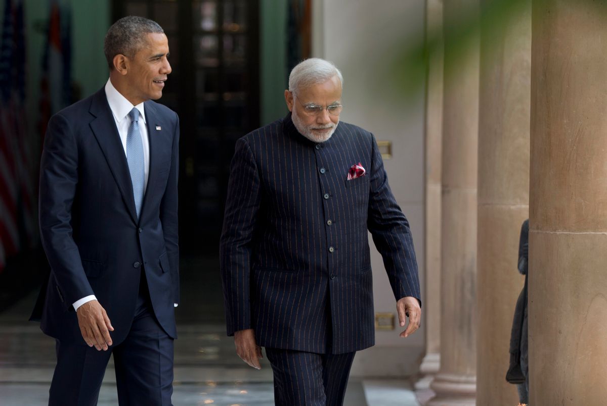 President Barack Obama walks with the Indian Prime Minister Narendra Modi to be photographed by media at the Hyderabad House in, New Delhi, India, Sunday, Jan. 25, 2015. (AP Photo/Carolyn Kaster)  (Carolyn Kaster)