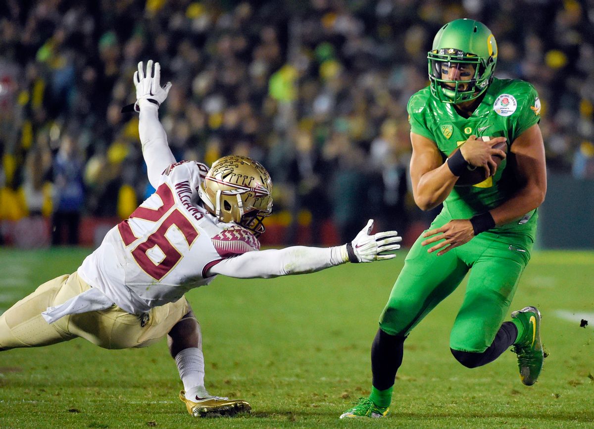 Oregon quarterback Marcus Mariota, right, scores past Florida State defensive back P.J. Williams during the second half of the Rose Bowl NCAA college football playoff semifinal, Thursday, Jan. 1, 2015, in Pasadena, Calif. (AP Photo/Mark J. Terrill) (AP)