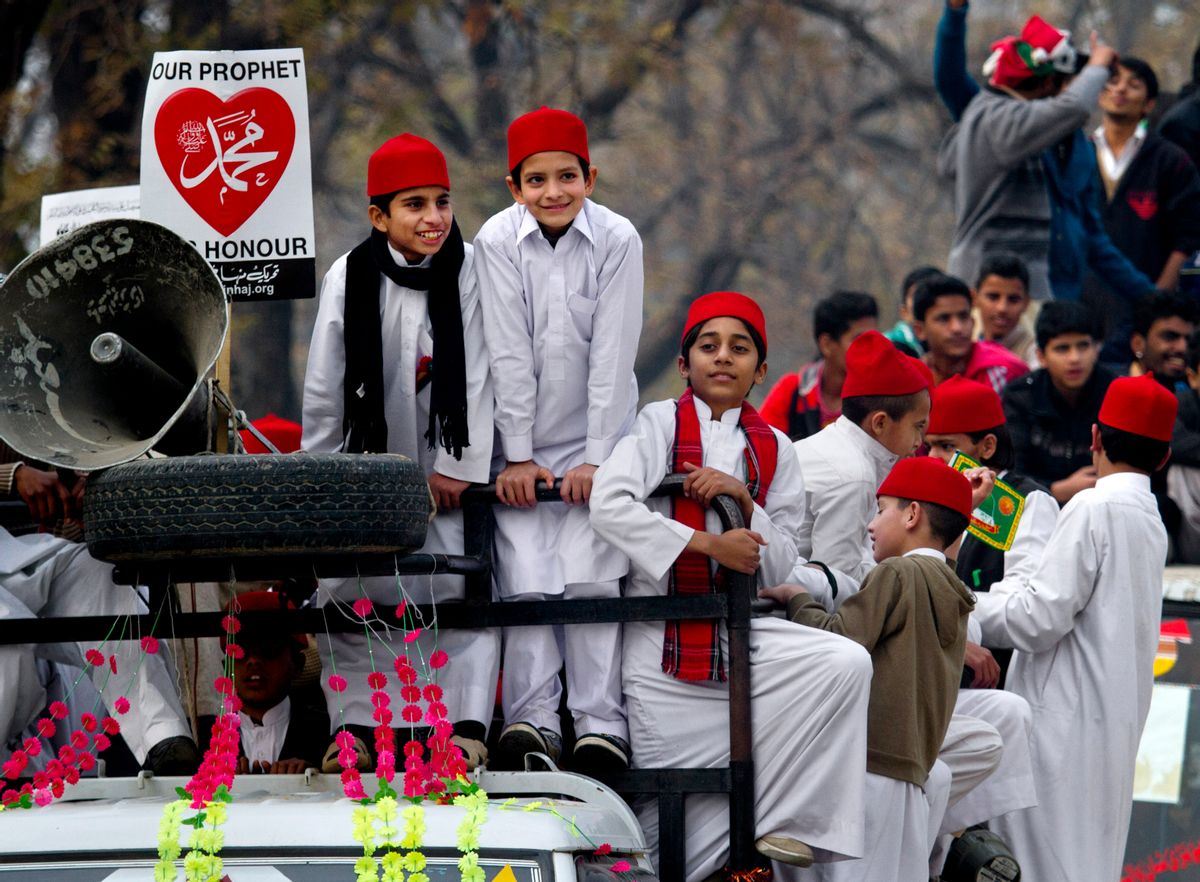 Pakistani boys take part in a rally marking the birthday of Islam's Prophet Muhammad in Islamabad, Pakistan, Sunday, Jan. 4, 2015. Thousands of Pakistani Muslims celebrated by participating in religious ceremonies and distributing free meals for the poor. (AP Photo/Anjum Naveed) (AP)