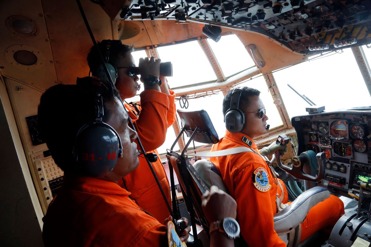 Crew of Indonesian Air Force C-130 airplane of the 31st Air Squadron scan the horizon during a search operation for the missing AirAsia flight 8501 jetliner over the waters of Karimata Strait in Indonesia, Monday, Dec. 29, 2014. Search planes and ships from several countries on Monday were scouring Indonesian waters over which an AirAsia jet disappeared, more than a day into the region's latest aviation mystery. AirAsia Flight 8501 vanished Sunday in airspace thick with storm clouds on its way from Surabaya, Indonesia, to Singapore. (AP Photo/Dita Alangkara) (Dita Alangkara)