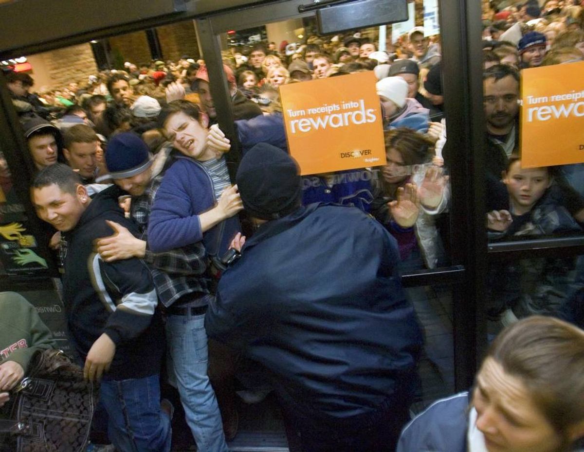 Eager shoppers push through the front doors of the Boise Townsquare mall as they are opened at 1 a.m. Friday in Boise.  (Darin Oswald)
