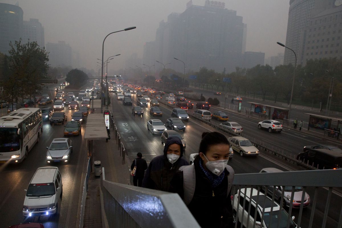 FILE - In this file photo taken Saturday, Nov. 29, 2014, pedestrians wear masks against the pollution as they cross an overhead bridge over a busy highway in Beijing, China. A slick new documentary on China's environmental woes has racked up more than 175 million online views in two days, underscoring growing concern in the country over the impact of air, water and soil pollution. Costing about $160,000 to make, the documentary won praise Sunday March 1, 2015, from new Chinese Environment Minister Chen Jining. (AP Photo/Ng Han Guan, File) (AP)