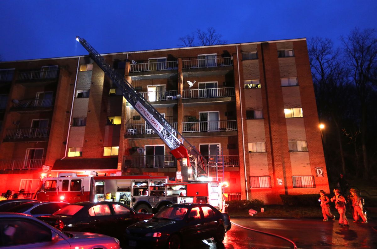 Firefighters work at the scene of a fire at King Towers apartment complex inn Cincinatti that took the life of Cincinatti firefighter Daryl Gordon, Thursday, March 26, 2015. The city says Gordon, 54, died at a hospital Thursday morning after being pulled from a building. Authorities said all residents were safe, but several residents were treated for smoke inhalation.  (AP Photo/The Enquirer, Liz Dufour)  (AP)