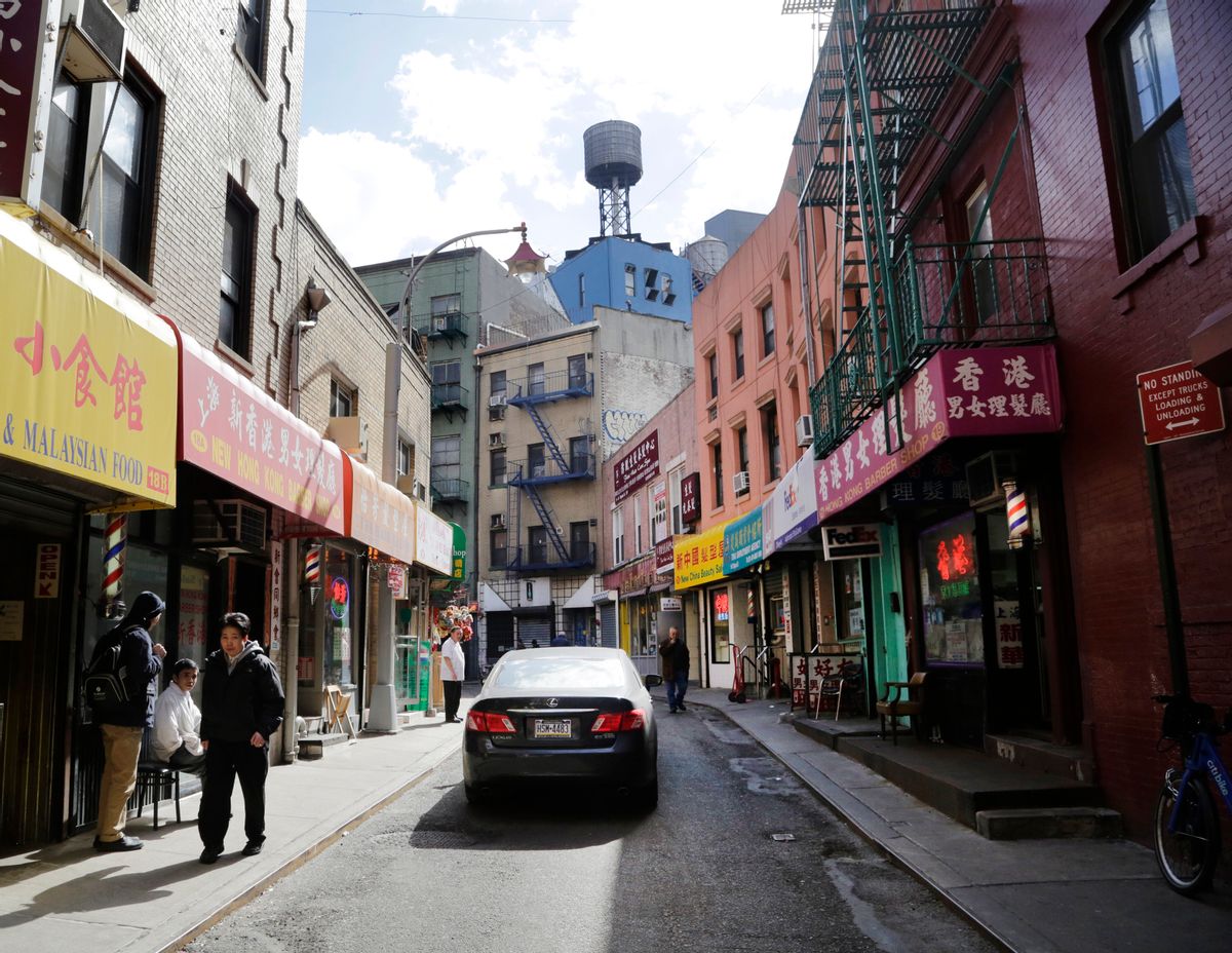 People gather on Doyers Street in the Chinatown neighborhood of New York, Wednesday, March 18, 2015. (AP Photo/Mark Lennihan) (AP)