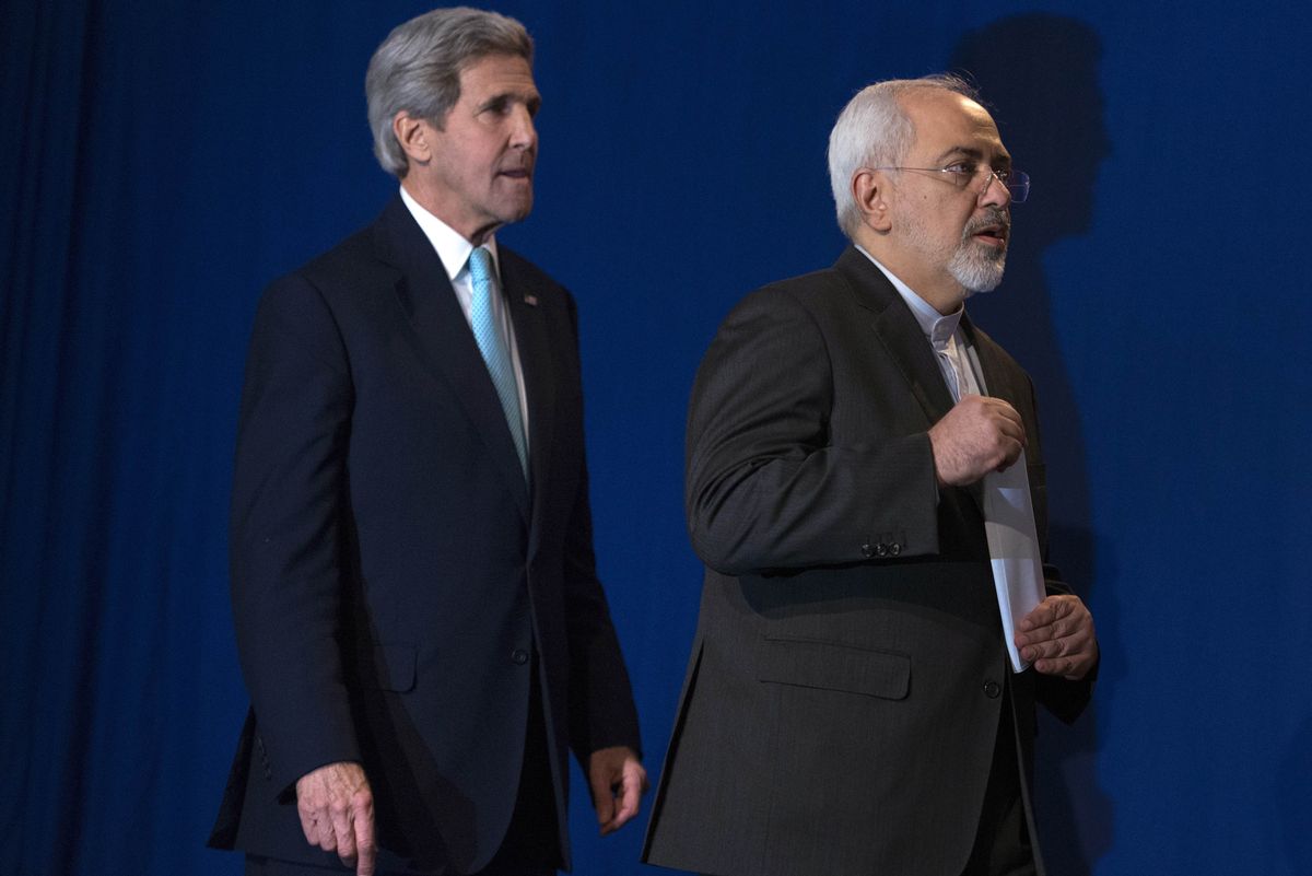 US Secretary of State John Kerry, left, and Iranian Foreign Minister Javad Zarif after Iran nuclear program talks finished with extended sessions.     (AP Photo/Brendan Smialowski)