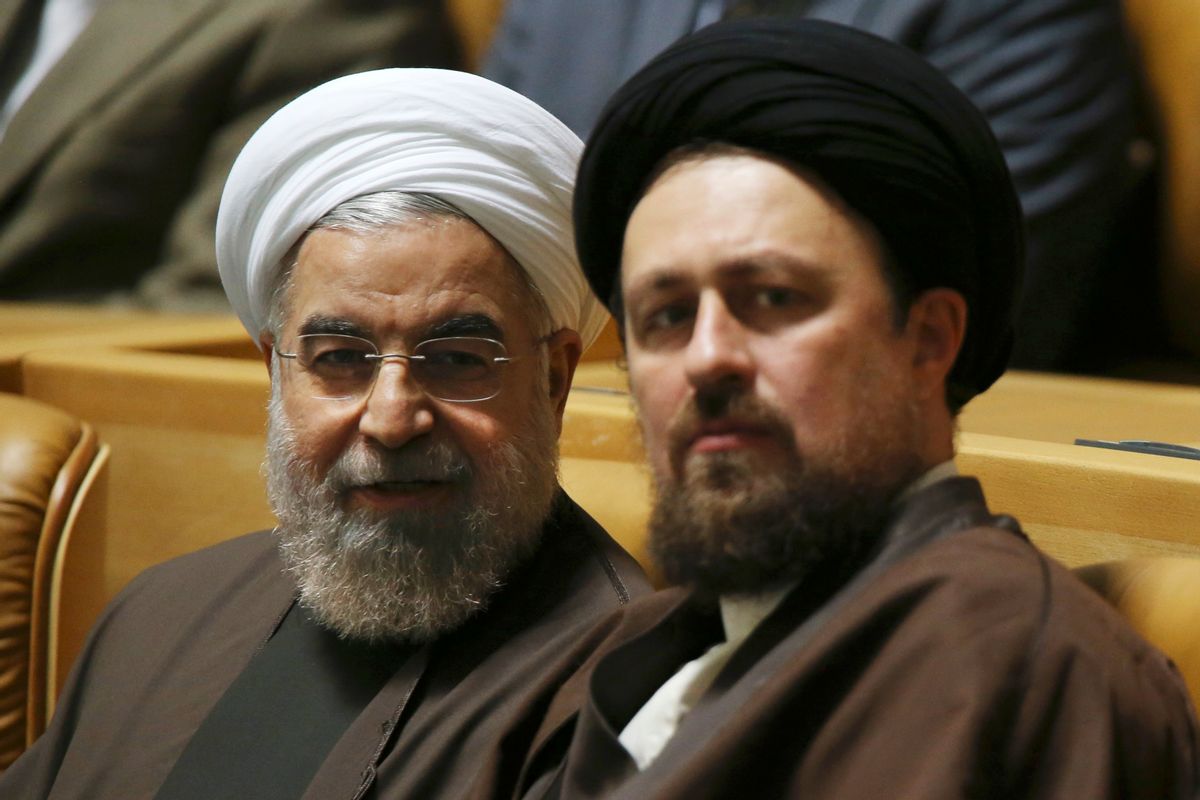 Iranian President Hassan Rouhani, left, talks to Hassan Khomeini, grandson of late revolutionary founder Ayatollah Khomeini. (      (AP/Vahid Salemi)