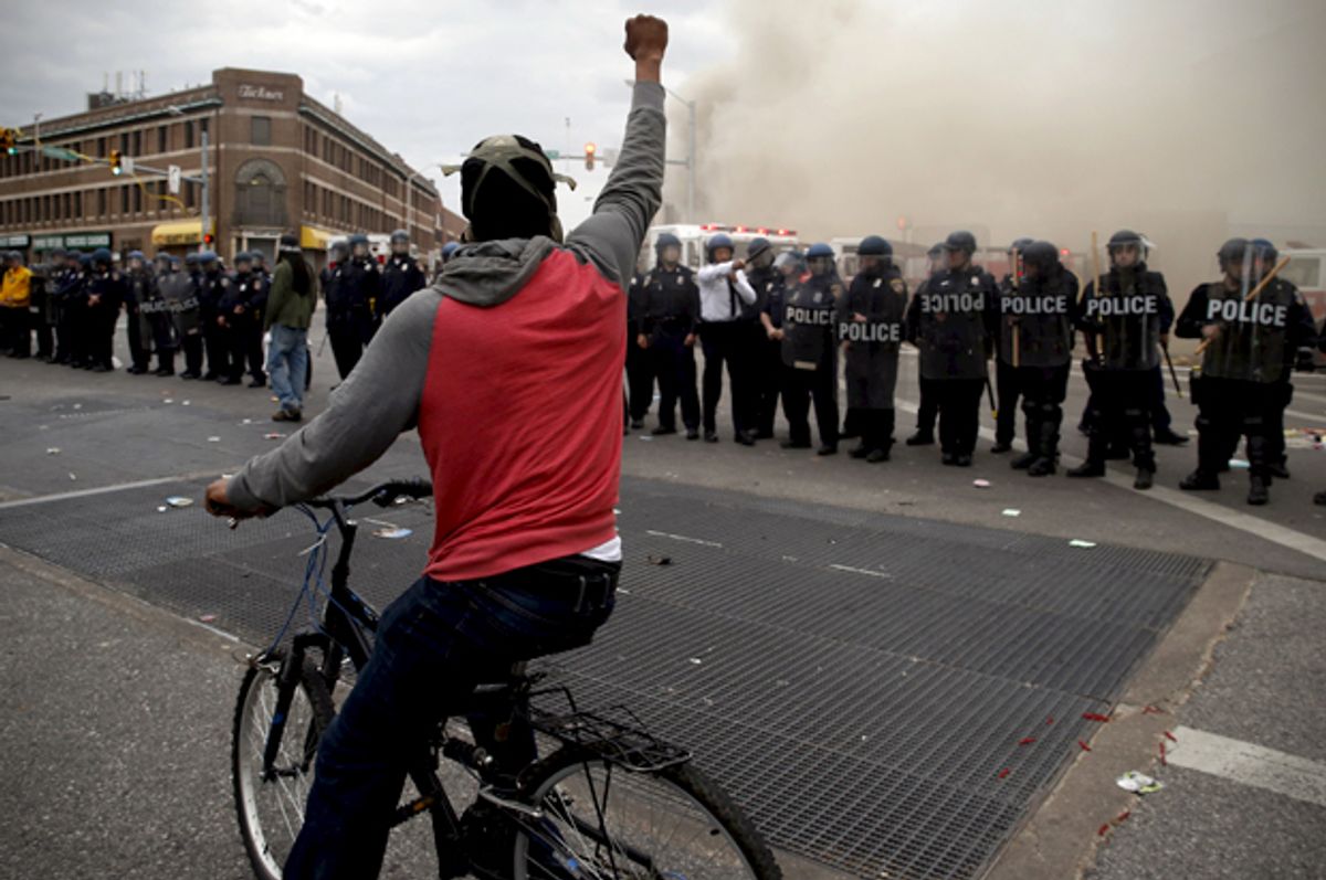 A protestor faces a line of police during clashes in Baltimore, Maryland April 27, 2015.           (Reuters/Jim Bourg)