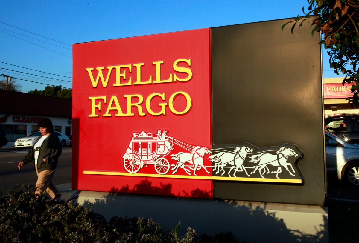 FILE - In this Jan. 18, 2011 file photo, a pedestrian walks by a Wells Fargo bank branch in Los Angeles. (AP)