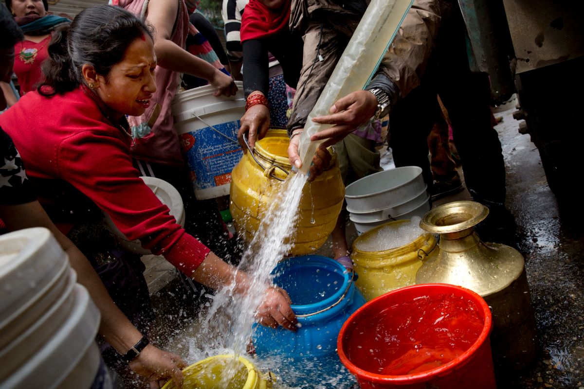 Nepalese collect water distributed in a tanker in Kathmandu, Nepal, Wednesday, April 29, 2015. While many villages across Nepal affected by Saturdays earthquake are still waiting for rescue and relief teams, life in the capital, Kathmandu, is slowly returning to normal. (AP Photo/Bernat Amangue) (Bernat Armangue)