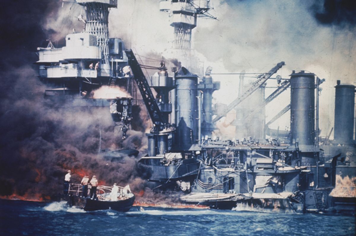 A small boat rescues a USS West Virginia crew member from the water after the Japanese bombing of Pearl Harbor, Hawaii on Dec. 7, 1941.   (AP)