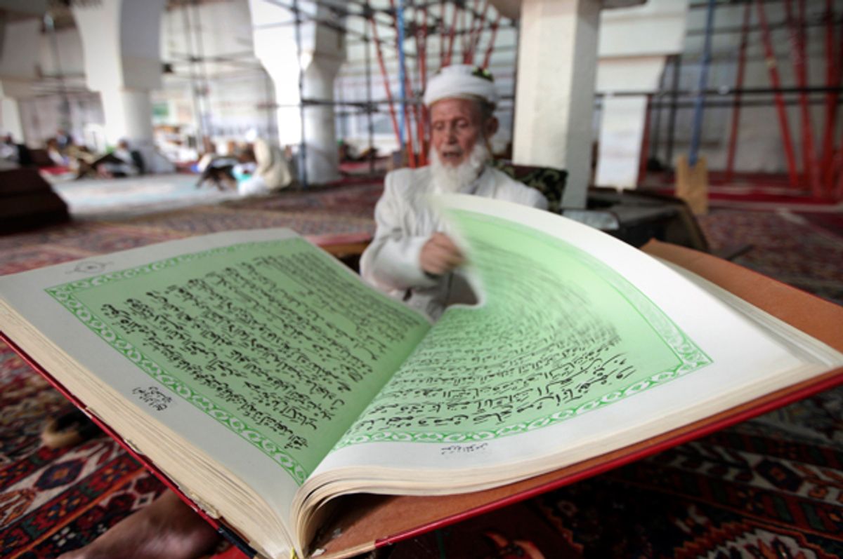 A man reads the Koran in a mosque in Sanaa, June 27, 2014.    (Reuters/Mohamed Al-sayaghi)