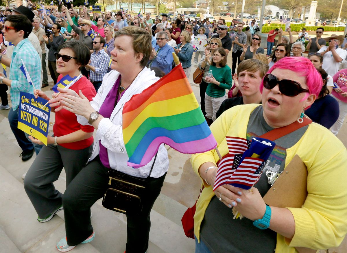 FILE - In this March 31, 2015 file photo, Barbara Hall, right, of Little Rock, joins others at a rally against a new religious objections law outside the Capitol in Little Rock, Ark. The national focus on whether new religious objections laws in Indiana and Arkansas could be used to discriminate against gays and lesbians has boosted efforts for broader civil rights law protections in those and other states. (AP Photo/Danny Johnston, File) (AP)