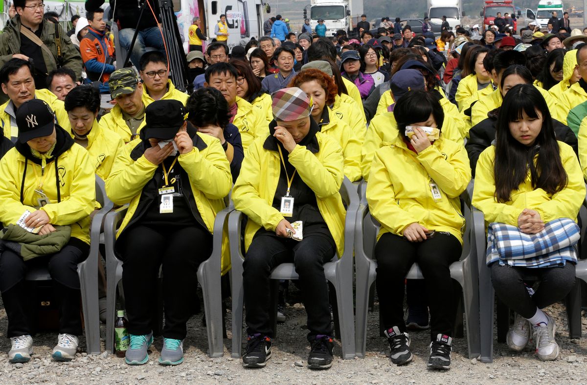 Relatives of the victims of a South Korean ferry sinking, that killed more than 300 people, weep during a ceremony on the eve of the first anniversary of the Sewol ferry sinking at a port in Jindo, South Korea, Wednesday, April 15, 2015. (AP Photo/Ahn Young-joon) (Ahn Young-joon)