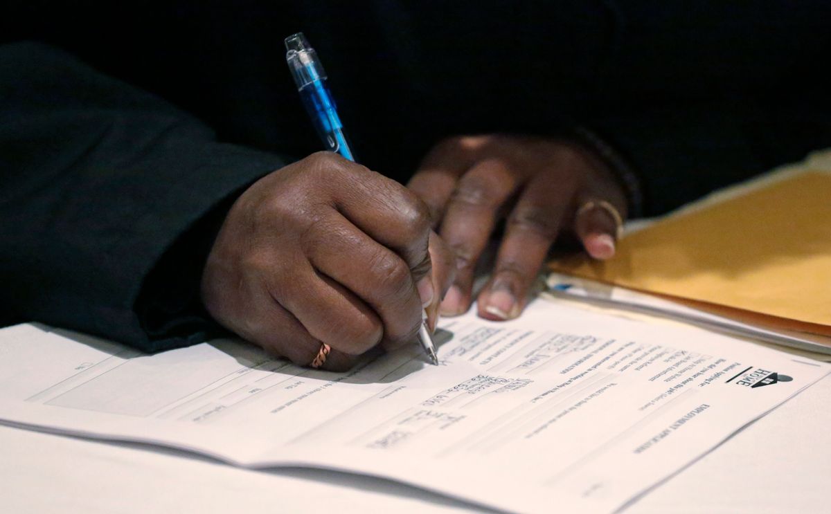 A job seeker fills out an application during a National Career Fairs job fair Wednesday, April 22, 2015, in Chicago. (AP Photo/M. Spencer Green)  (AP)
