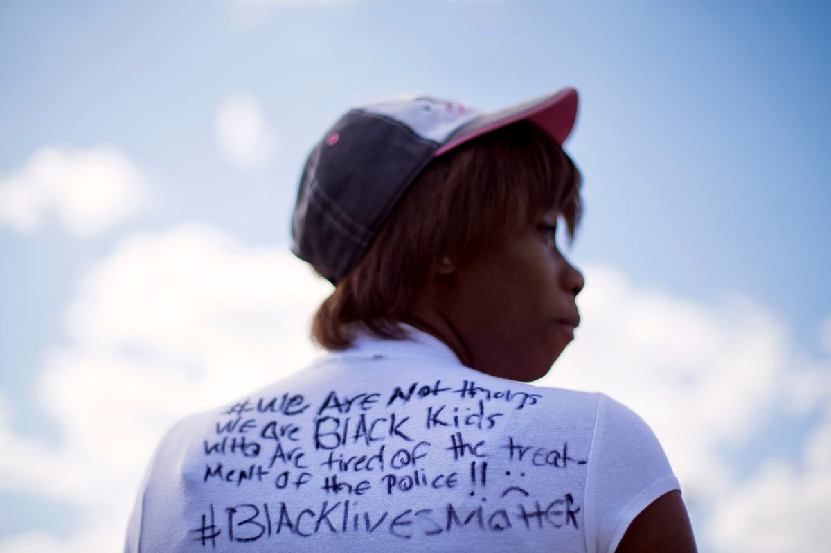 Alize LeGrange, 18, wears a T-shirt she made in response to Baltimore Mayor Stephanie Rawlings-Blake's comments about "thugs" trying to tear down the city as she waits for a bus at the Mondawmin Metro Station          (AP Photo/David Goldman)