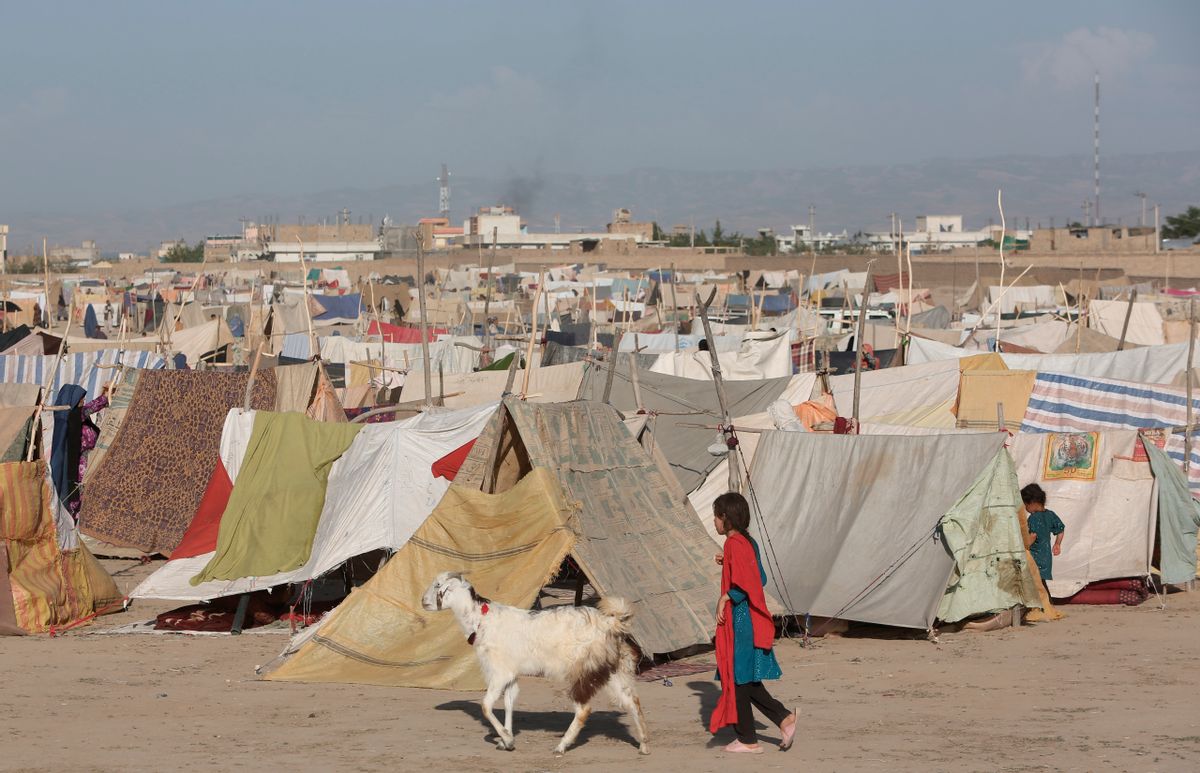 In this Thursday, May 21, 2015 photo, an Afghan refugee girl walks with her goat at a camp on the outskirts of Kunduz province, north of Kabul, Afghanistan. When the Taliban descended a month ago on Dam Shakh, a hamlet on the wheat-growing plains of northern Afghanistans Kunduz province, nobody was prepared. By the time they were beaten back for the provincial capital of Kunduz, more than 100,000 people were forced from their homes and total of 204 war-wounded were admitted to Kunduzs only trauma hospital, run by French NGO Medecins Sans Frontieres in less than a month. (AP Photo/Rahmat Gul) (AP Photo/Rahmat Gul)